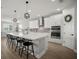 Bright and airy kitchen with white cabinets, quartz countertops, stainless steel appliances, and pendant lighting at 923 Whimbrel Run, Bradenton, FL 34212