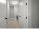 Hallway laundry room featuring side-by-side washer and dryer, with light tile floor at 923 Whimbrel Run, Bradenton, FL 34212