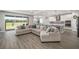 Open living space features a comfortable couch with kitchen access and bright natural light at 923 Whimbrel Run, Bradenton, FL 34212