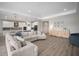 Open-concept living space with a plush couch and stylish kitchen featuring bar seating at 923 Whimbrel Run, Bradenton, FL 34212