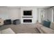 Bright living room featuring modern fireplace with electric insert and large screen television at 923 Whimbrel Run, Bradenton, FL 34212
