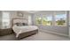 Light-filled main bedroom with carpet, and large windows bringing the outside in at 923 Whimbrel Run, Bradenton, FL 34212