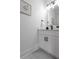 Stylized bathroom featuring a white vanity and modern black fixtures and hardware at 925 E Chelsea St, Tampa, FL 33603