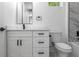 A clean bathroom with a white vanity and toilet, with minimalist black fixtures at 925 E Chelsea St, Tampa, FL 33603