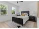 Cozy bedroom with large windows, stylish black bed frame and matching nightstands at 925 E Chelsea St, Tampa, FL 33603