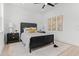 Modern bedroom featuring a black bed frame, neutral rug, and stylish wall decor at 925 E Chelsea St, Tampa, FL 33603