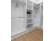 Walk-in closet with shelving, rods, and wood-look flooring at 925 E Chelsea St, Tampa, FL 33603