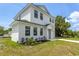 Charming two-story house showcasing a well-manicured front yard and landscaping at 925 E Chelsea St, Tampa, FL 33603