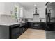 Modern kitchen with white cabinets, black countertops, subway tile backsplash, and stainless steel appliances at 925 E Chelsea St, Tampa, FL 33603