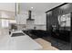 Modern kitchen featuring white cabinets, black countertops, subway tile backsplash and stainless steel appliances at 925 E Chelsea St, Tampa, FL 33603