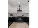 Modern kitchen featuring white cabinets, black countertops, subway tile backsplash and stainless steel appliances at 925 E Chelsea St, Tampa, FL 33603