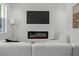 Bright living room with fireplace, TV, modern white sectional, and natural light at 925 E Chelsea St, Tampa, FL 33603