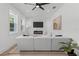 Bright living room with fireplace, TV, modern white sectional, and natural light at 925 E Chelsea St, Tampa, FL 33603