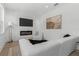 Bright living room with fireplace, TV, modern white sectional, and natural light at 925 E Chelsea St, Tampa, FL 33603