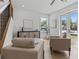 Bright living room featuring a staircase, modern furniture and French doors at 925 E Chelsea St, Tampa, FL 33603