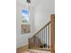 Staircase featuring wood railings, black balusters, and a modern chandelier at 925 E Chelsea St, Tampa, FL 33603