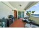 Spacious balcony features outdoor kitchen, furniture, and scenic waterfront views at 1003 Bellasol Way # 9203, Apollo Beach, FL 33572