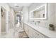 Elegant bathroom boasts marble floors, large mirror, dual sinks, and modern fixtures for a luxurious experience at 1003 Bellasol Way # 9203, Apollo Beach, FL 33572