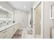 Modern bathroom features double vanity, marble countertops, and a glass-enclosed shower at 1003 Bellasol Way # 9203, Apollo Beach, FL 33572