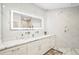 Luxurious bathroom with marble accents, double vanity, and illuminated mirror at 1003 Bellasol Way # 9203, Apollo Beach, FL 33572