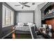 Cozy bedroom with a daybed, dark wood floors, and a well-lit workspace at 1003 Bellasol Way # 9203, Apollo Beach, FL 33572