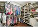 Spacious walk-in closet with custom shelving and hardwood flooring for optimal organization and storage at 1003 Bellasol Way # 9203, Apollo Beach, FL 33572