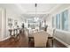 Bright dining room with tray ceiling, hardwood floors, and views out large windows at 1003 Bellasol Way # 9203, Apollo Beach, FL 33572