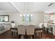 Bright dining room adjacent to the living room featuring hardwood floors and tray ceilings at 1003 Bellasol Way # 9203, Apollo Beach, FL 33572