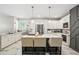 Bright kitchen features white cabinetry, an island with seating, and stainless steel appliances at 1003 Bellasol Way # 9203, Apollo Beach, FL 33572