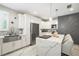 Bright kitchen features white cabinetry, an island with seating, and stainless steel appliances at 1003 Bellasol Way # 9203, Apollo Beach, FL 33572
