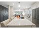 Bright kitchen features white cabinetry, an island with seating, and stainless steel appliances at 1003 Bellasol Way # 9203, Apollo Beach, FL 33572