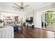 Spacious living room with hardwood floors, large sectional, and access to screened patio at 1003 Bellasol Way # 9203, Apollo Beach, FL 33572