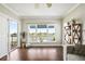 Bright living room showcasing water views from the expansive picture window and private balcony access at 1003 Bellasol Way # 9203, Apollo Beach, FL 33572