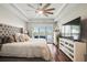 Serene main bedroom features tray ceiling, shuttered window views, and modern furnishings at 1003 Bellasol Way # 9203, Apollo Beach, FL 33572