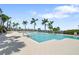 Relax by the pool surrounded by lush palm trees and scenic water views at 1003 Bellasol Way # 9203, Apollo Beach, FL 33572