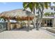 Resort-style tiki bar on a spacious patio, perfect for outdoor entertainment near the waterfront at 1003 Bellasol Way # 9203, Apollo Beach, FL 33572