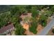 Property aerial view showing a cleared lot with mature trees, a partial view of a house, and street access at 10030 Lake Dr, Weeki Wachee, FL 34613