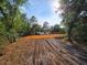 Cleared lot ready for construction with mature trees and views of the adjacent lake at 10030 Lake Dr, Weeki Wachee, FL 34613