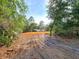 Cleared lot ready for construction with mature trees and views of the adjacent lake at 10030 Lake Dr, Weeki Wachee, FL 34613
