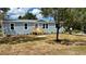 Charming single-story home with a new wooden porch and nicely manicured landscaping at 10030 Lake Dr, Weeki Wachee, FL 34613