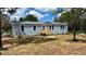 Charming single-story home with a new wooden porch and nicely manicured landscaping at 10030 Lake Dr, Weeki Wachee, FL 34613
