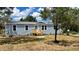 Charming single-story home with a new wooden porch and nicely manicured landscaping at 10030 Lake Dr, Weeki Wachee, FL 34613