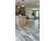 Bright, open-concept living area with hardwood floors, natural light, and kitchen access at 10030 Lake Dr, Weeki Wachee, FL 34613
