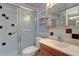 Cozy bathroom featuring a glass enclosed shower, vanity with mirror, and neutral color scheme at 10037 62Nd N Ter # 9, St Petersburg, FL 33708