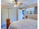 Bedroom with hardwood bed frame, ceiling fan, and closet, next to the sunroom at 10037 62Nd N Ter # 9, St Petersburg, FL 33708