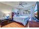 Comfortable bedroom with ceiling fan, a window with blinds, and stylish decor at 10037 62Nd N Ter # 9, St Petersburg, FL 33708