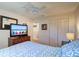 Bedroom with TV, closet, a ceiling fan and decoratively adorned with beachy accents at 10037 62Nd N Ter # 9, St Petersburg, FL 33708