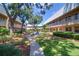 Serene courtyard featuring lush greenery, a walkway, and inviting outdoor seating at 10037 62Nd N Ter # 9, St Petersburg, FL 33708