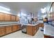 Spacious kitchen with wood cabinets, granite countertops and a center island with sink and countertop space at 10037 62Nd N Ter # 9, St Petersburg, FL 33708