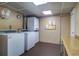 Functional laundry room equipped with multiple washers and dryers, ensuring convenience at 10037 62Nd N Ter # 9, St Petersburg, FL 33708